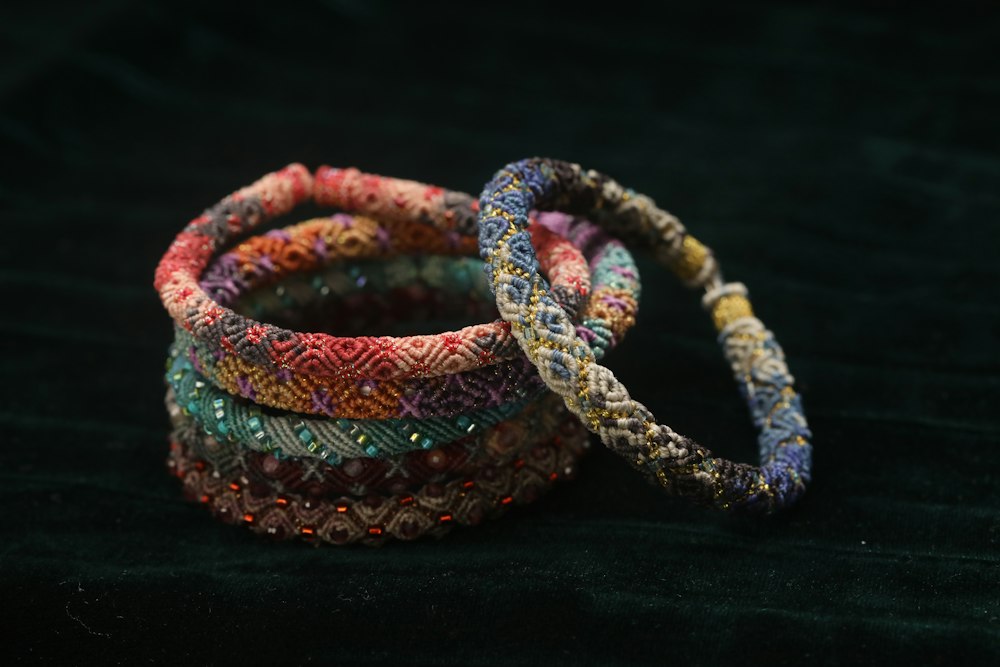 Red bead bracelets resting on dark fabric