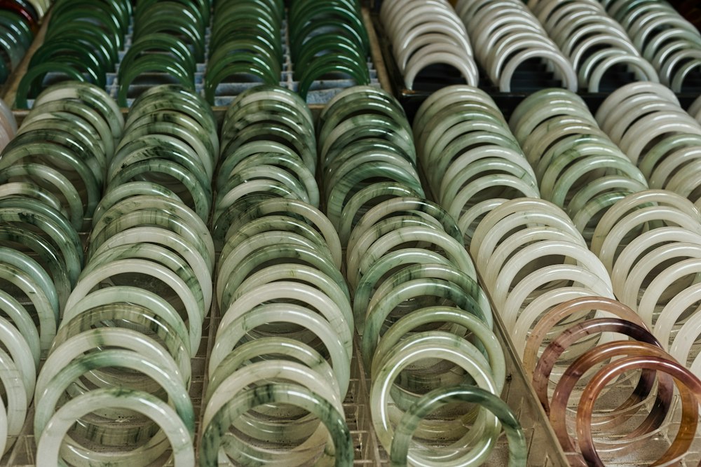 Rows of green and white jade bracelets in soft daylight